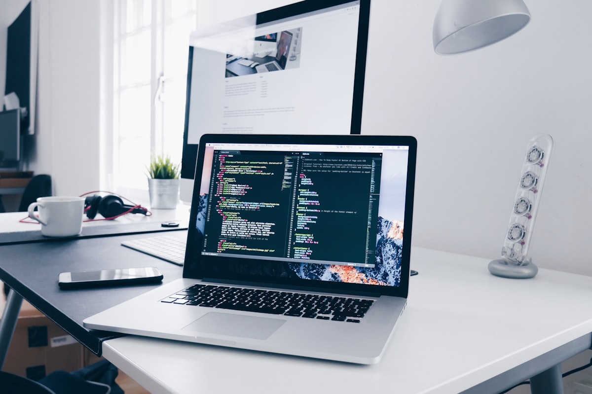 Embedded systems developer workspace with laptop and code